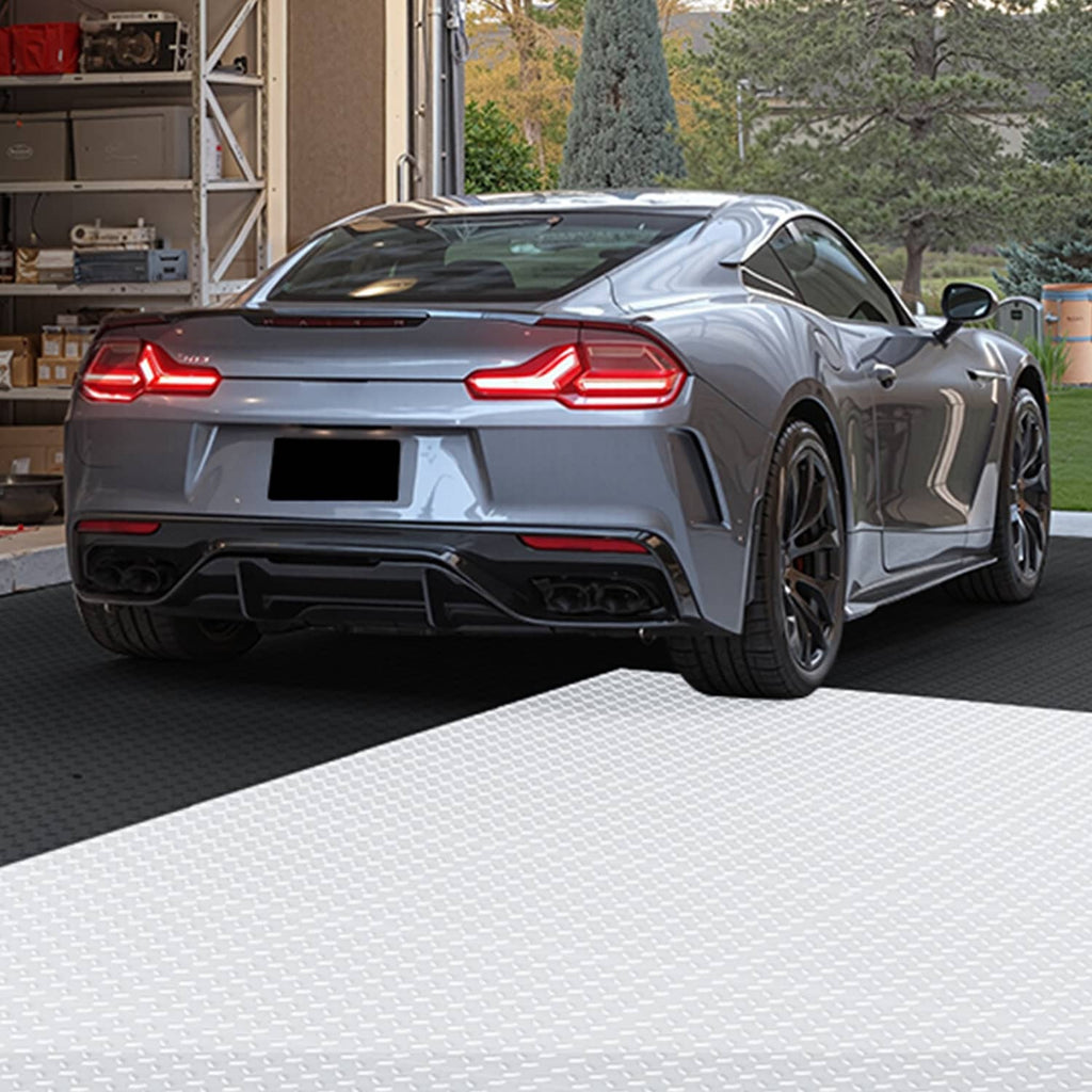 Interlocking PVC garage floor tiles with light gray diamond texture under a car