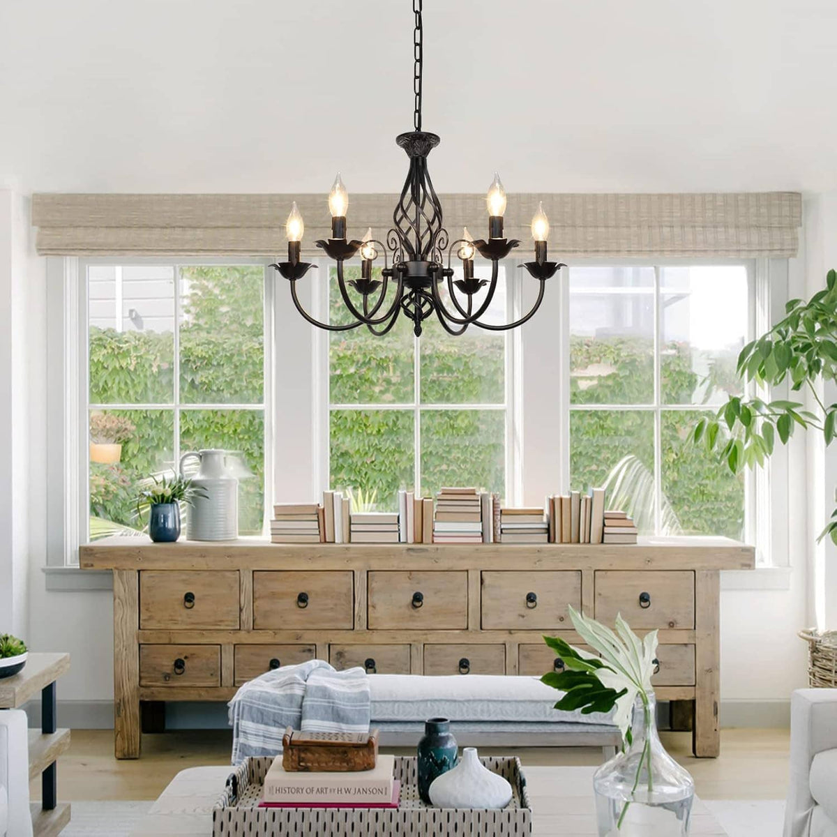 Black 6-light chandelier with curving candle arms and ornate lattice center above table