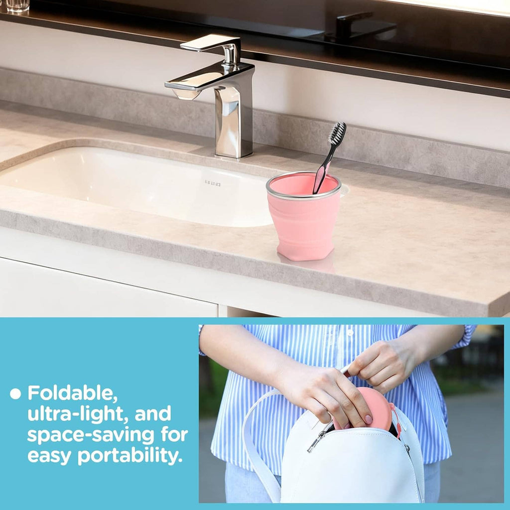 Collapsible silicone cup with lid, pink, near bathroom faucet on countertop