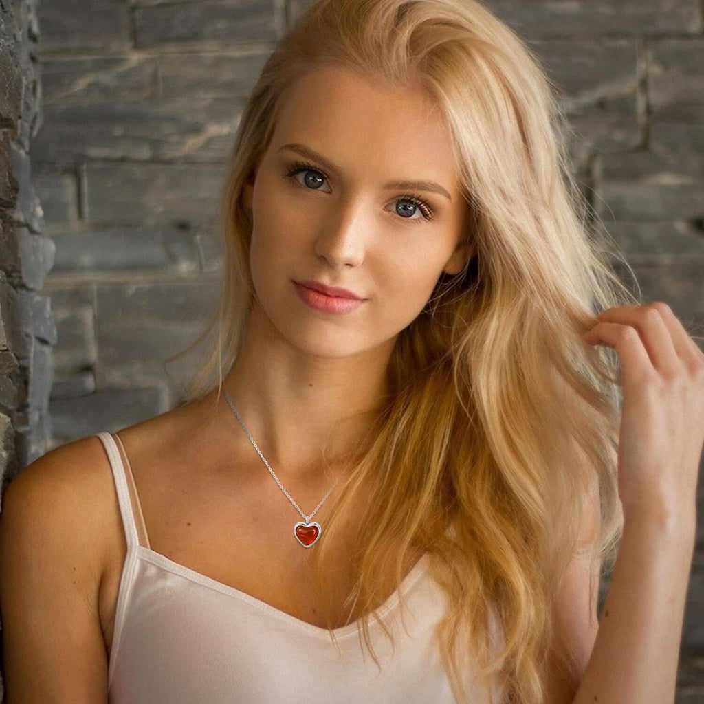 Women’s carnelian heart pendant necklace on silver chain, portrait view