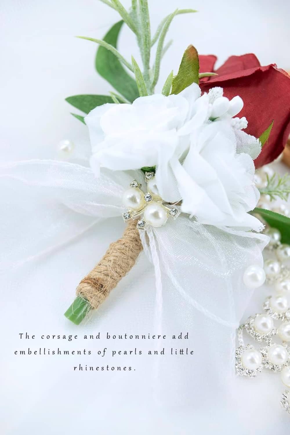 Artificial wrist corsage with white floral fabric, burgundy rose, faux pearls, green sprigs, raffia tie