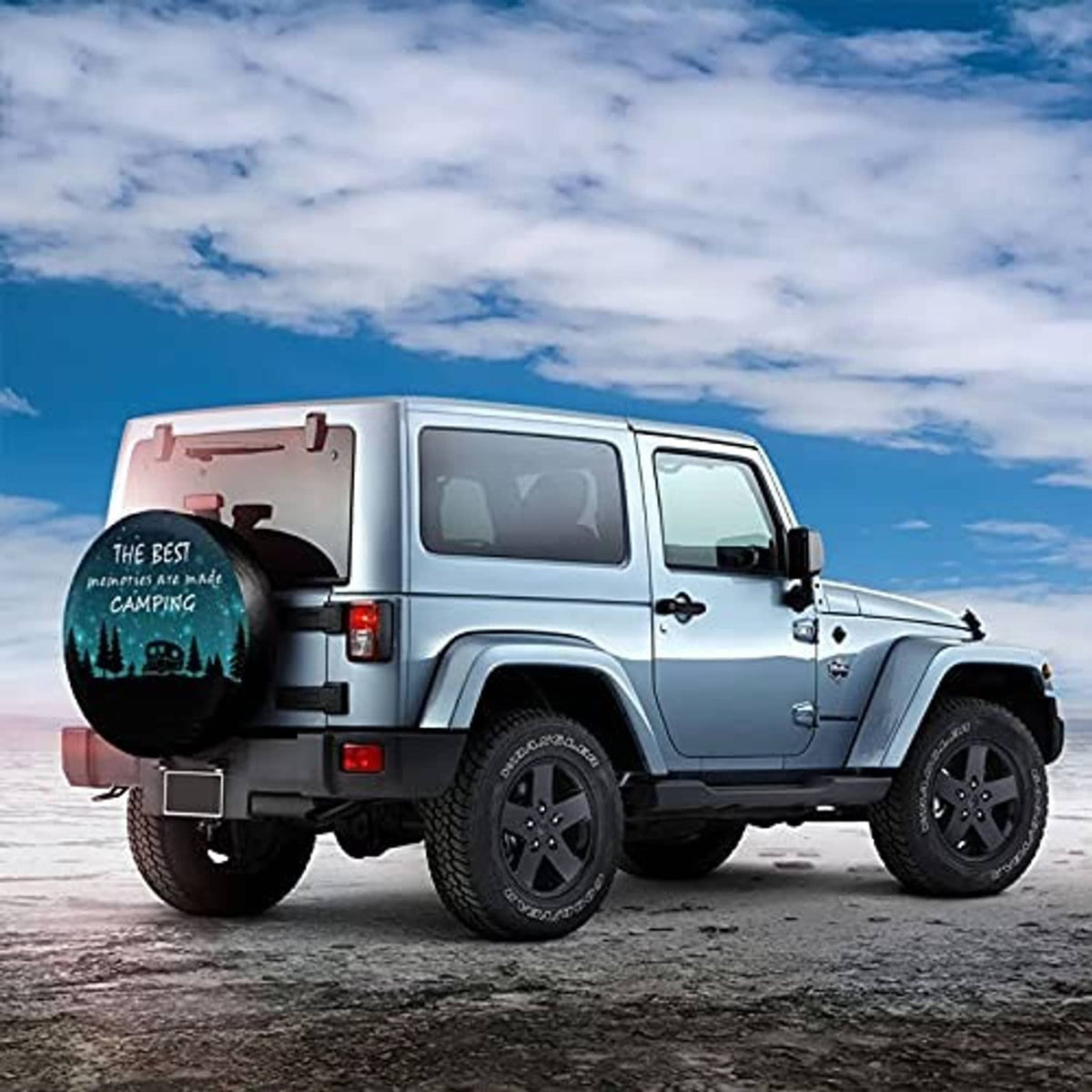 Spare tire cover with teal camping graphic on the back of a white off-road Jeep