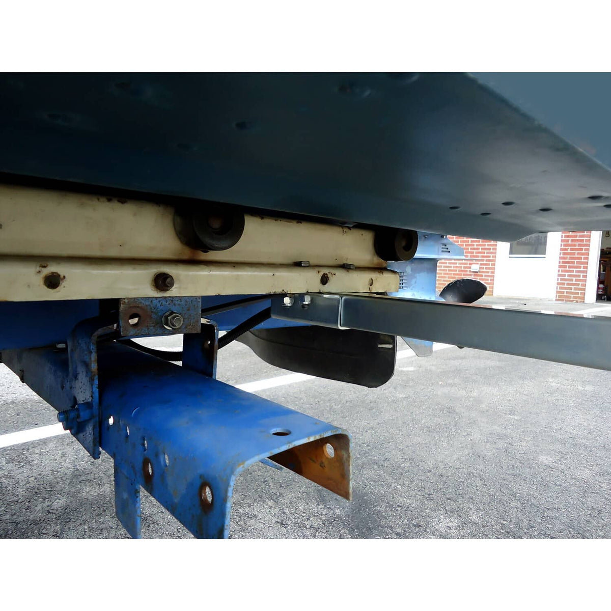 Underside view of mounted boat trailer bunk board guide bracket and support bar