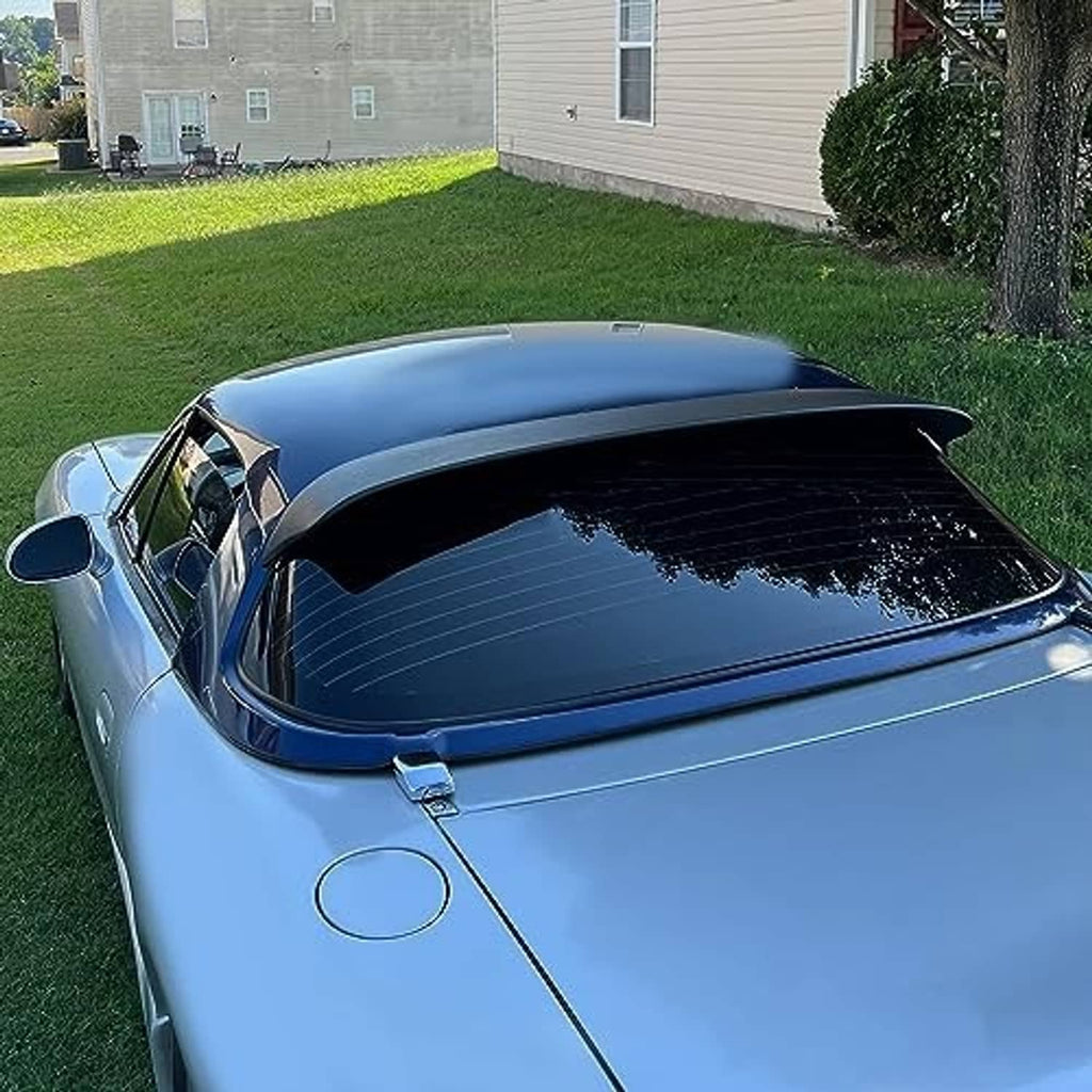 Matte black rear window roof spoiler installed on a blue hardtop car