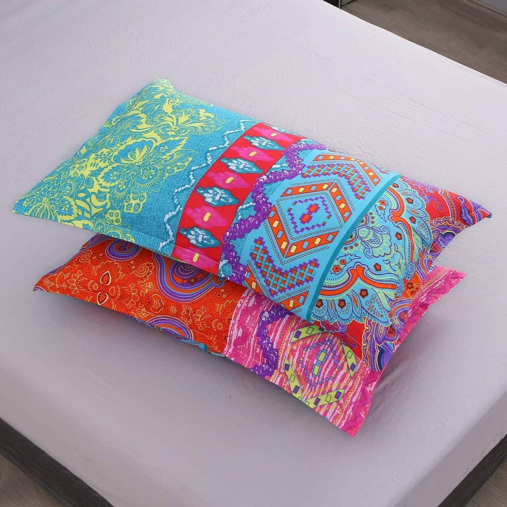Boho paisley pillow cases stacked on matching flat sheet with vibrant pattern