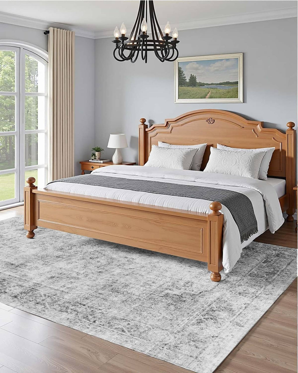 Gray distressed area rug under a bed, featuring low-pile abstract pattern