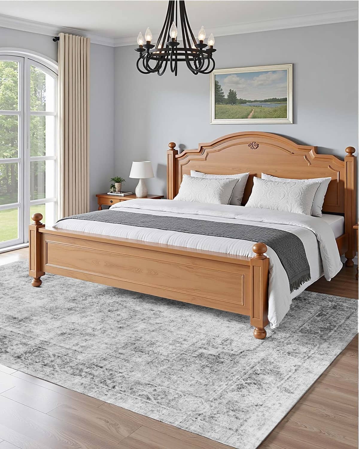 Gray distressed area rug under a bed, featuring low-pile abstract pattern