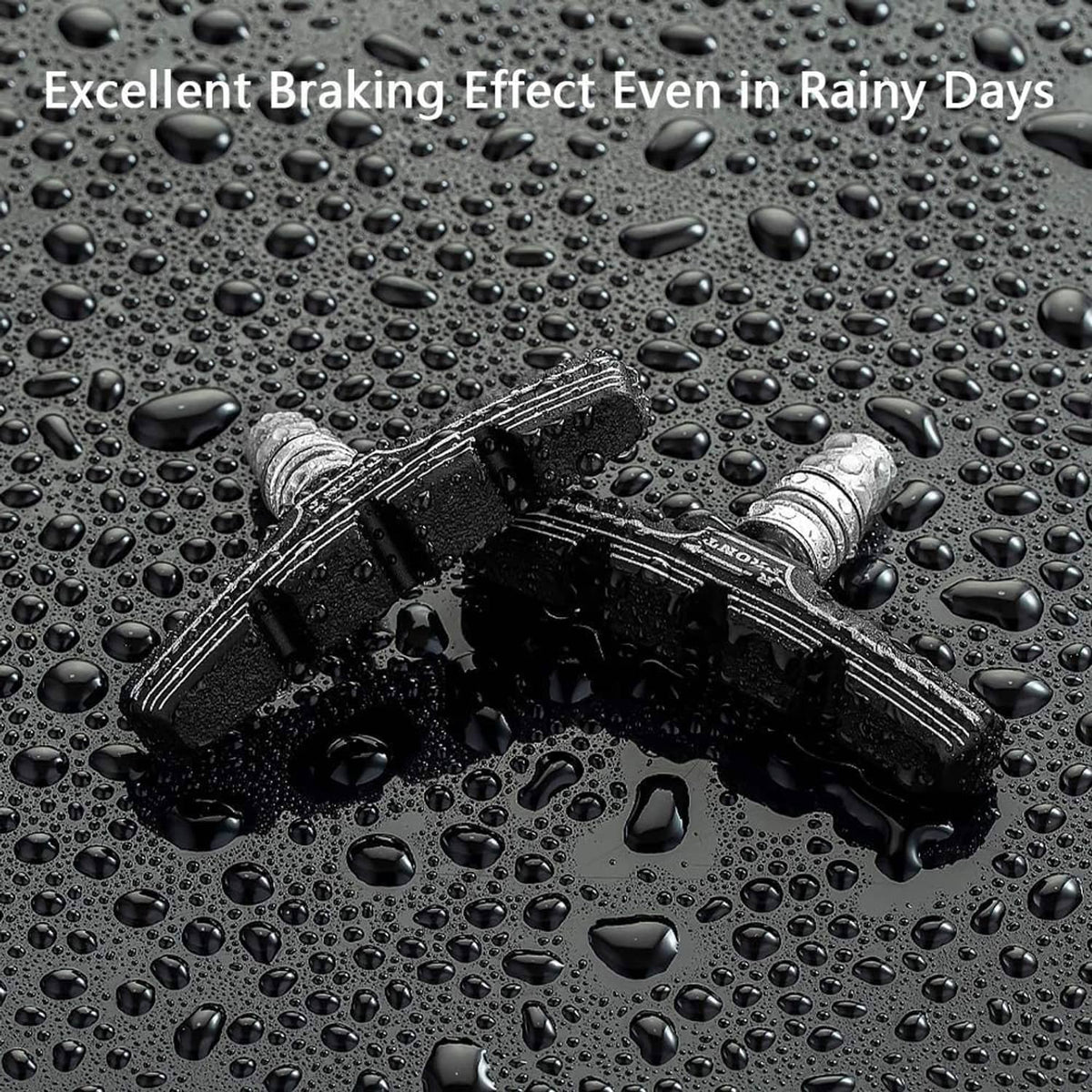Black textured rubber V-brake brake pads shown on a wet surface