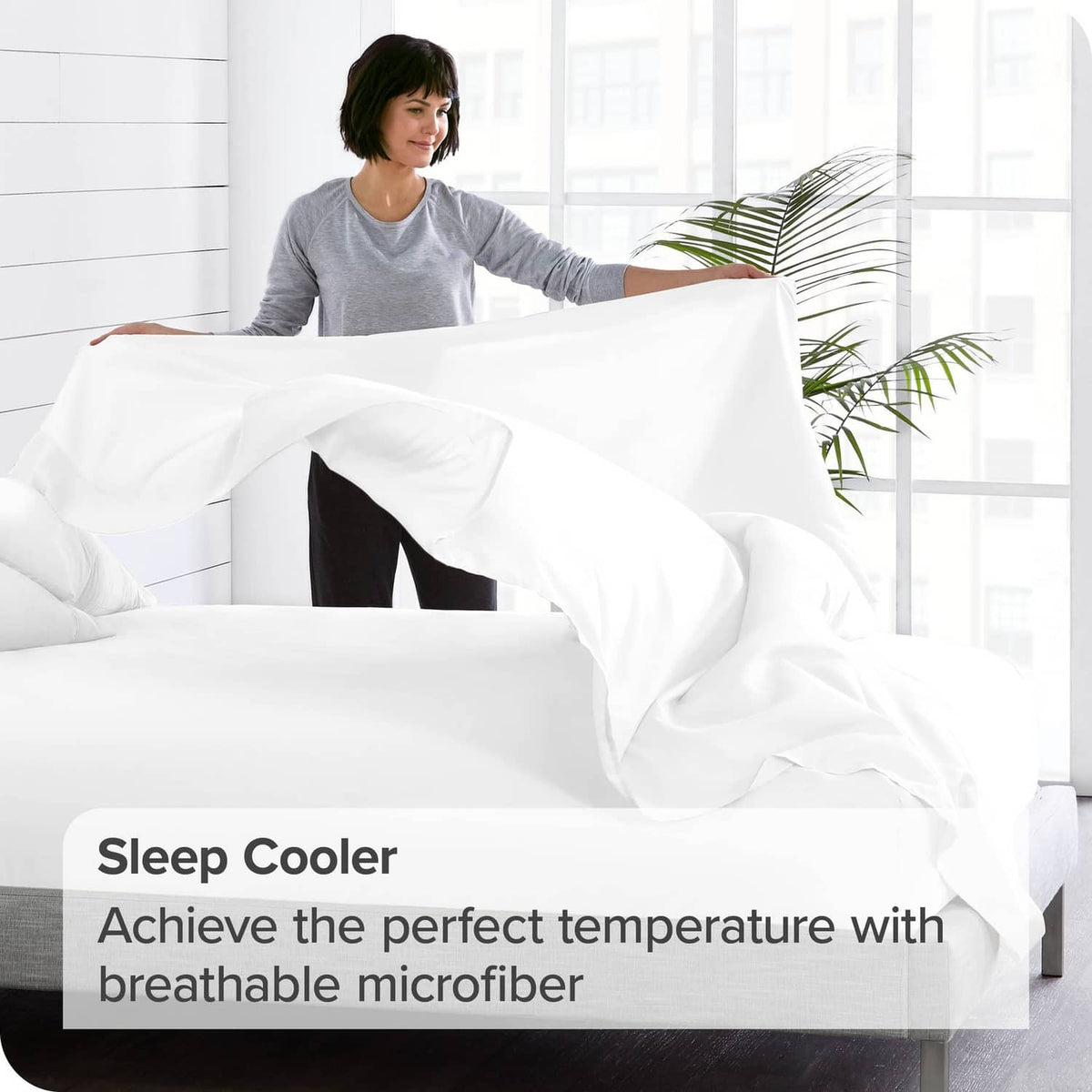 White microfiber flat sheet on bed, neatly tucked edge and smooth surface