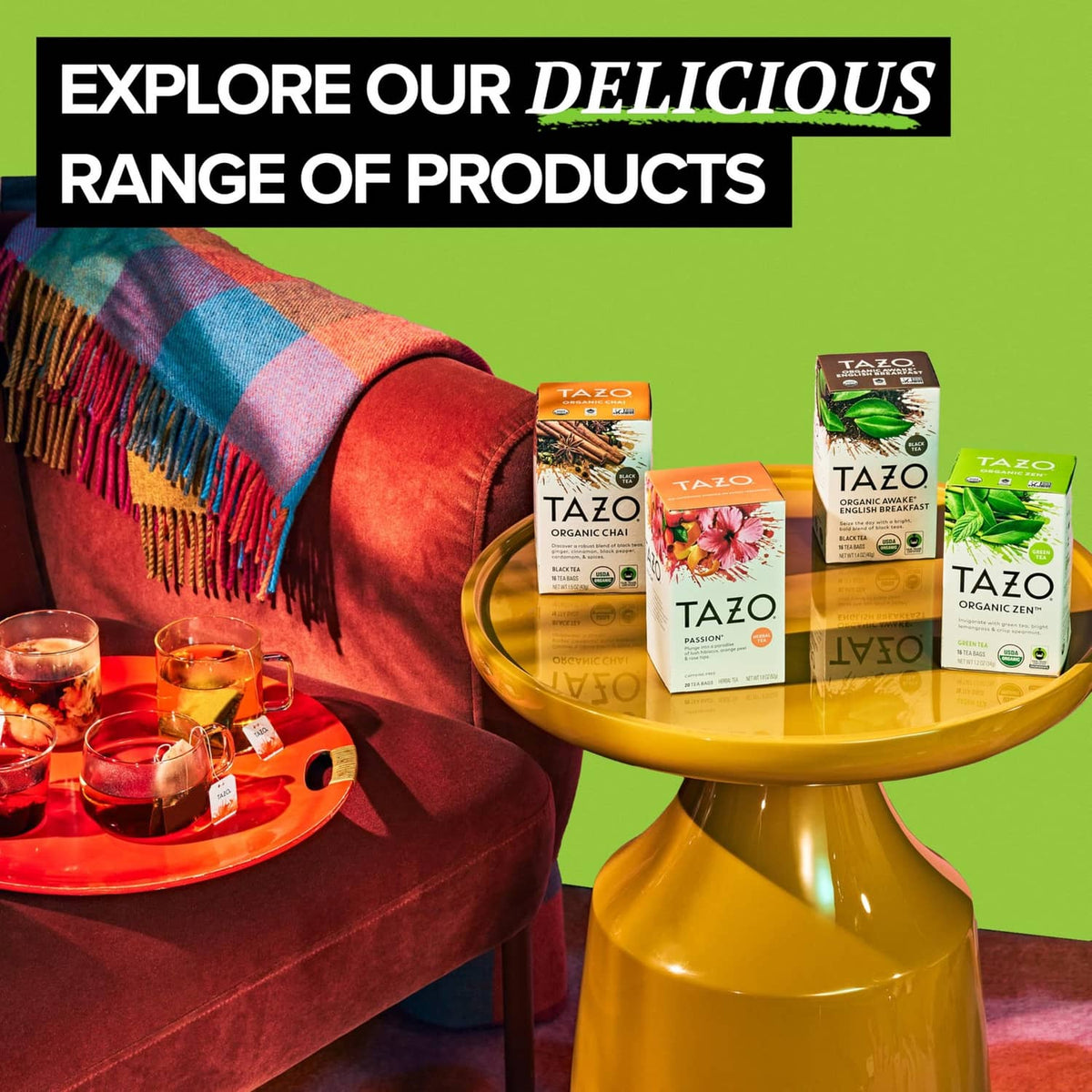 Multiple TAZO tea bag boxes on a stand with teacups nearby