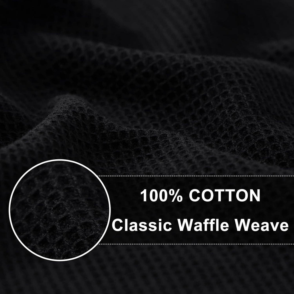 Black waffle weave cotton towel texture close-up, showing a honeycomb pattern