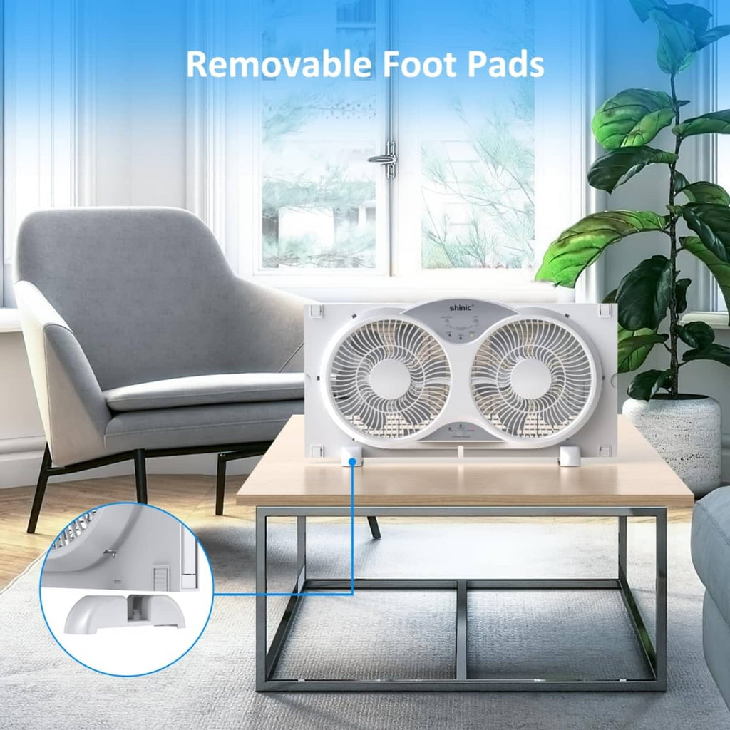 White window fan on a stand with removable foot pads, placed on a living room table