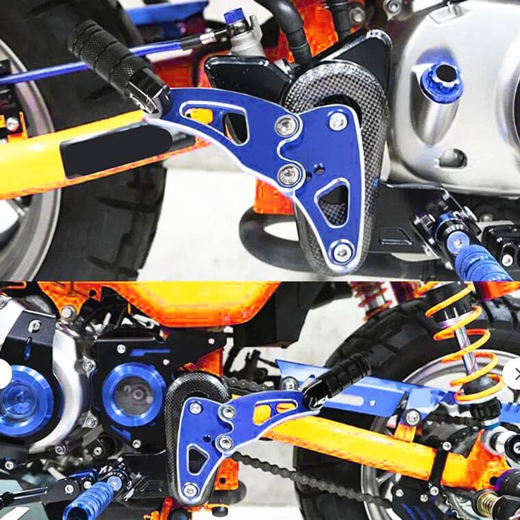 Blue rear passenger footrest mounted near engine with black rubber peg and bolts