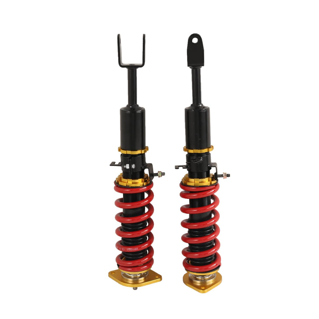 Two coilover shocks with red springs and gold bases, black steel body, upright view