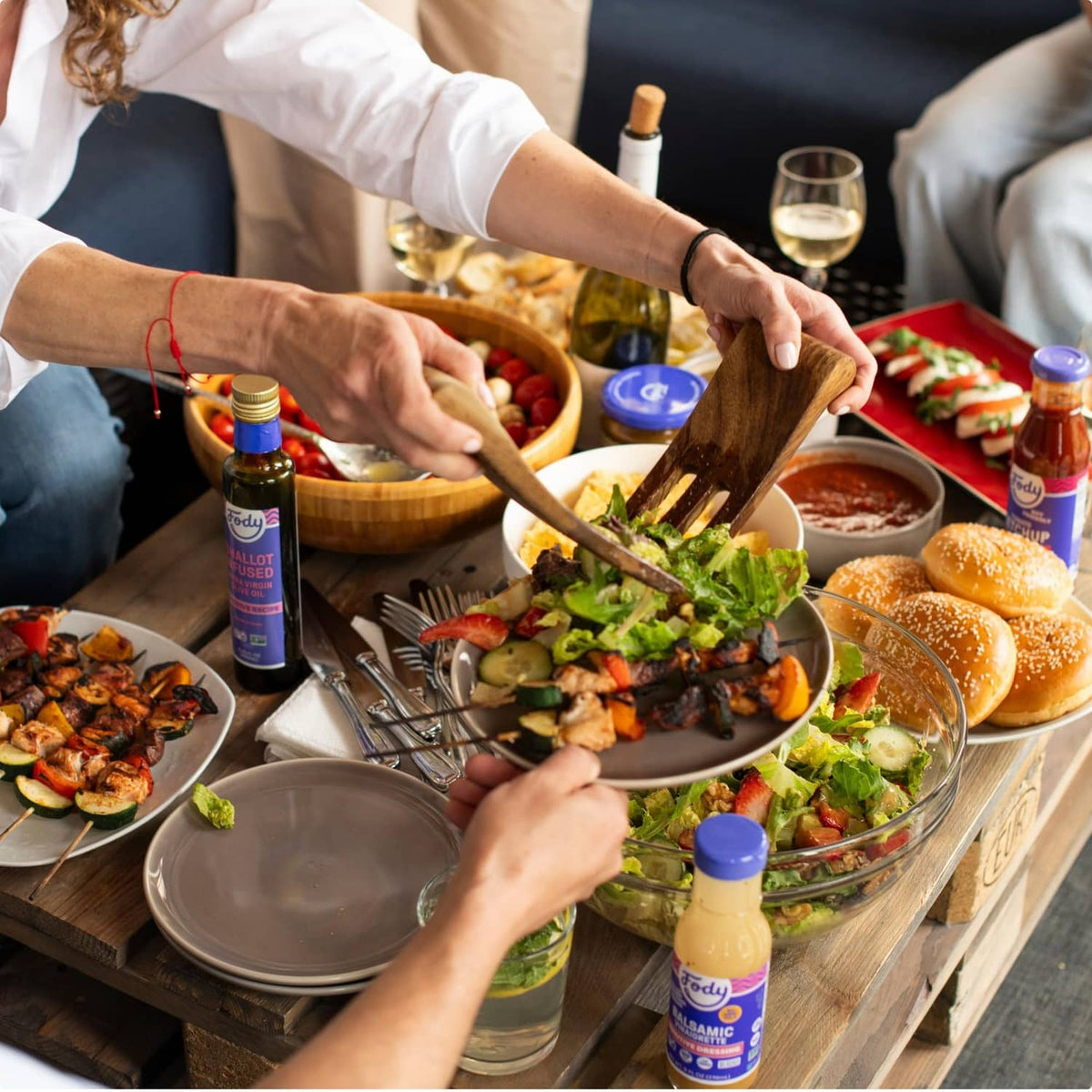 People seasoning food with Fody Foods sensitive everyday seasoning bottles