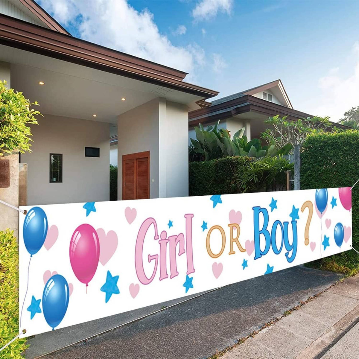 Gender reveal yard banner with “Girl or Boy” lettering, pink and blue balloons and stars