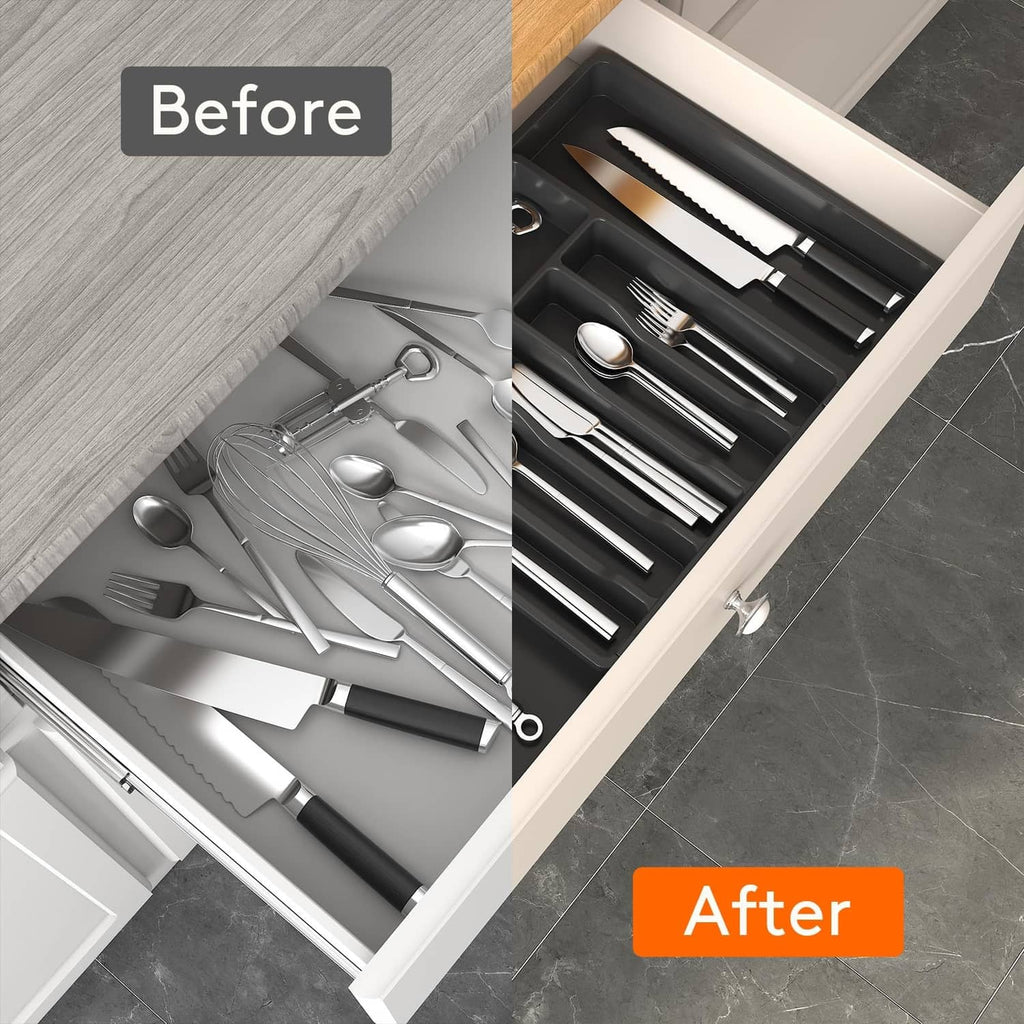 Dark cutlery organizer tray in a kitchen drawer, neatly arranged after use