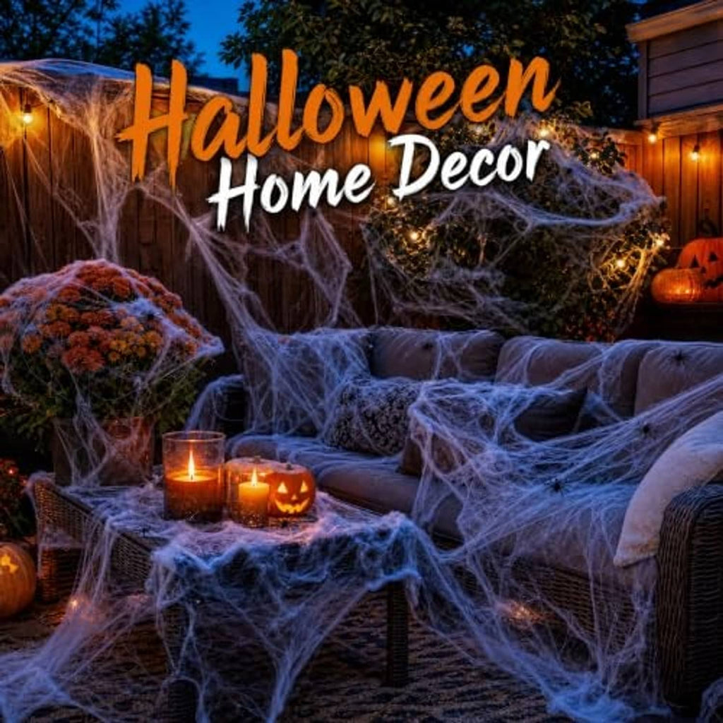 Outdoor Halloween spider webbing draped over patio seating with glowing jack-o-lanterns