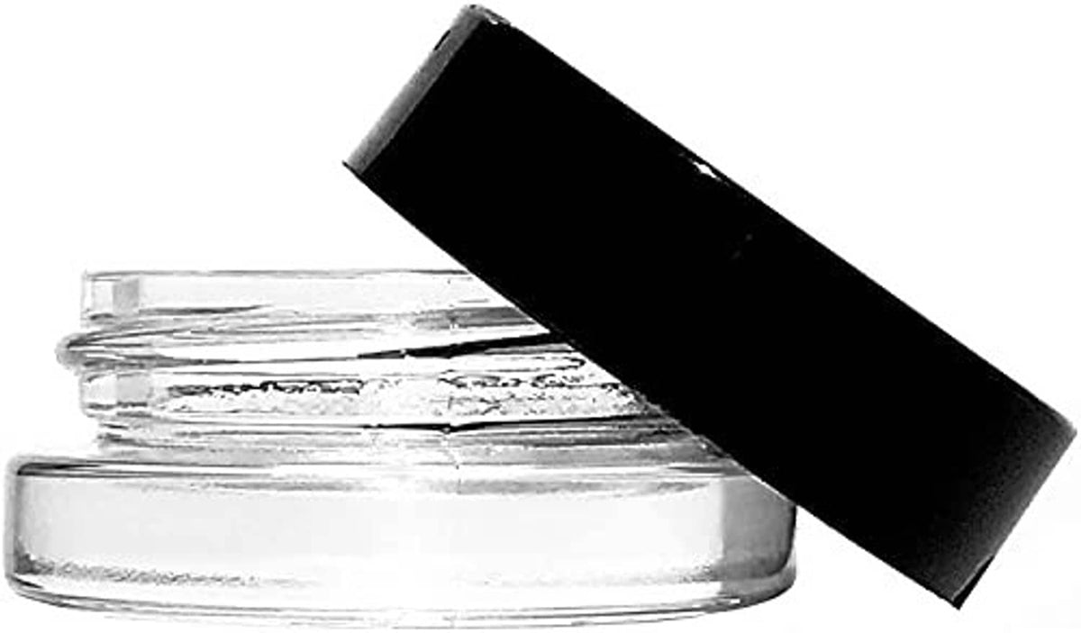 Clear glass jar with black lid tilted open