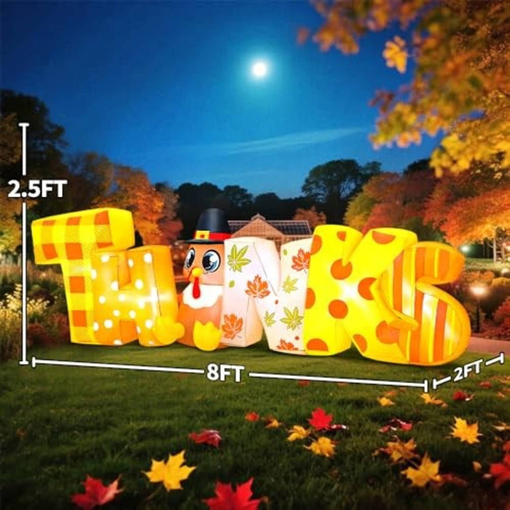 Large glowing Thanksgiving inflatable display: turkey mascot between colorful “THANKS” letters
