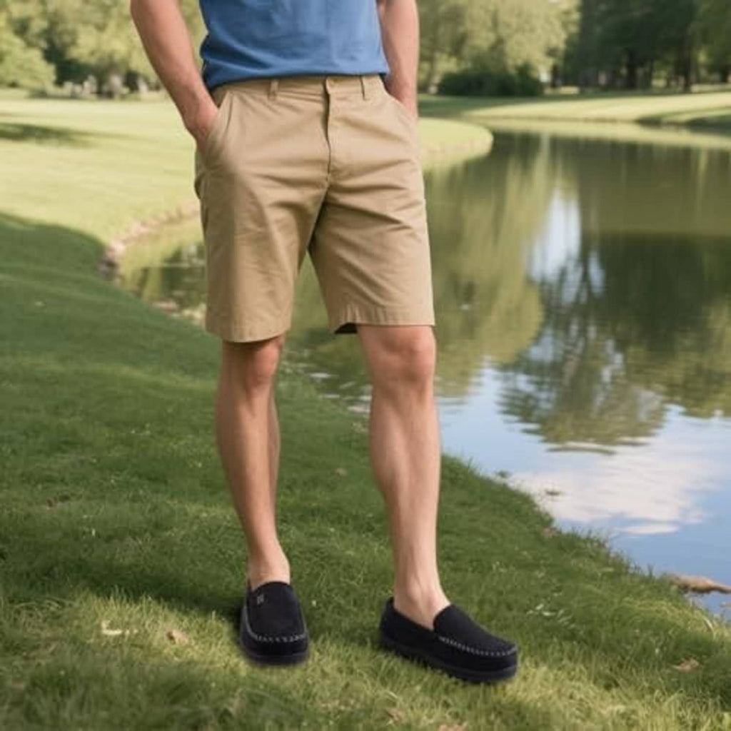 Black moccasin house slippers worn with beige shorts