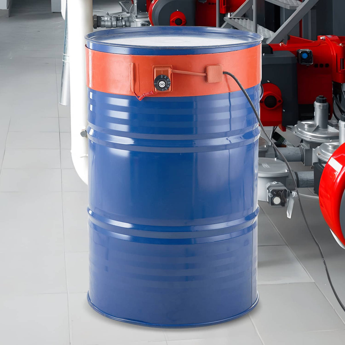 Blue 55-gallon metal drum with orange heater band and control box at front
