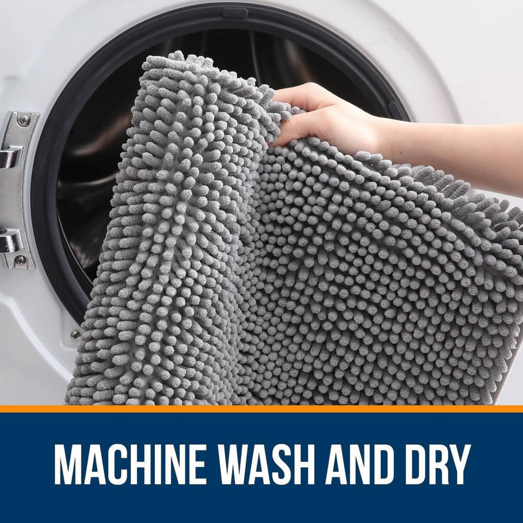 Grey chenille bathroom rug being placed into washing machine
