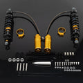 Set of rear motorcycle shocks with black coils, gold reservoirs, and mounting hardware