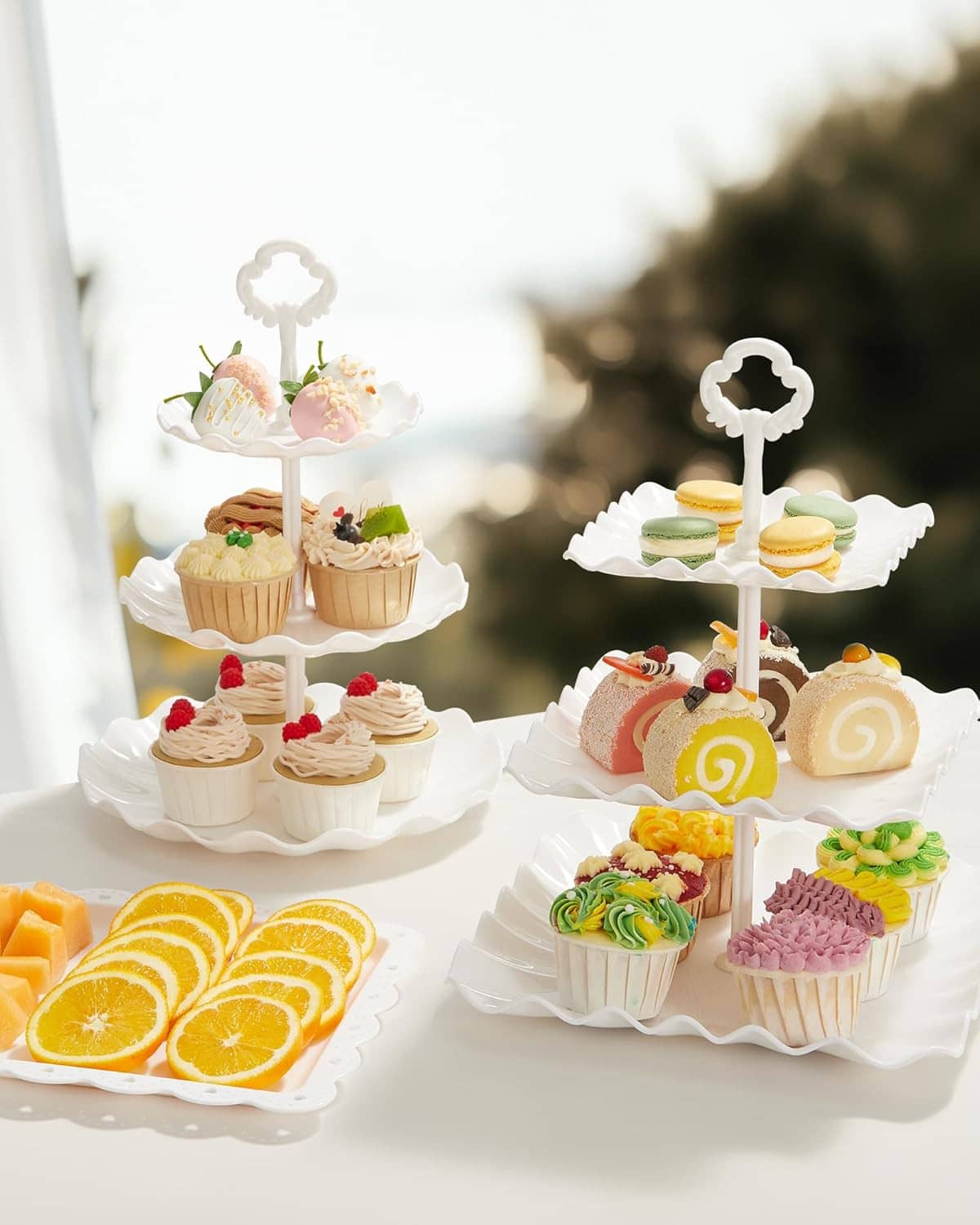 White tiered cupcake stands with decorated cupcakes and frosting desserts