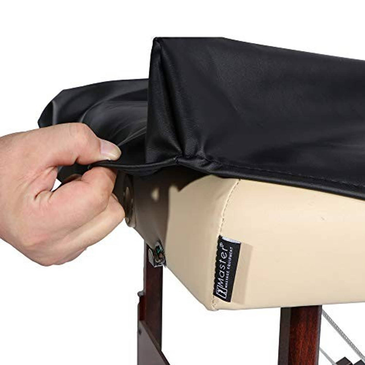 Hand fitting a black PU vinyl cover on a massage table, snug front edge