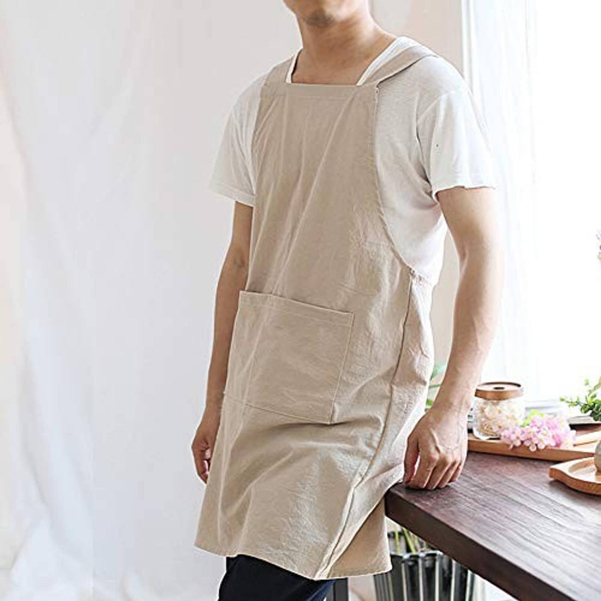 Light beige cross-back apron dress with large front pocket panel