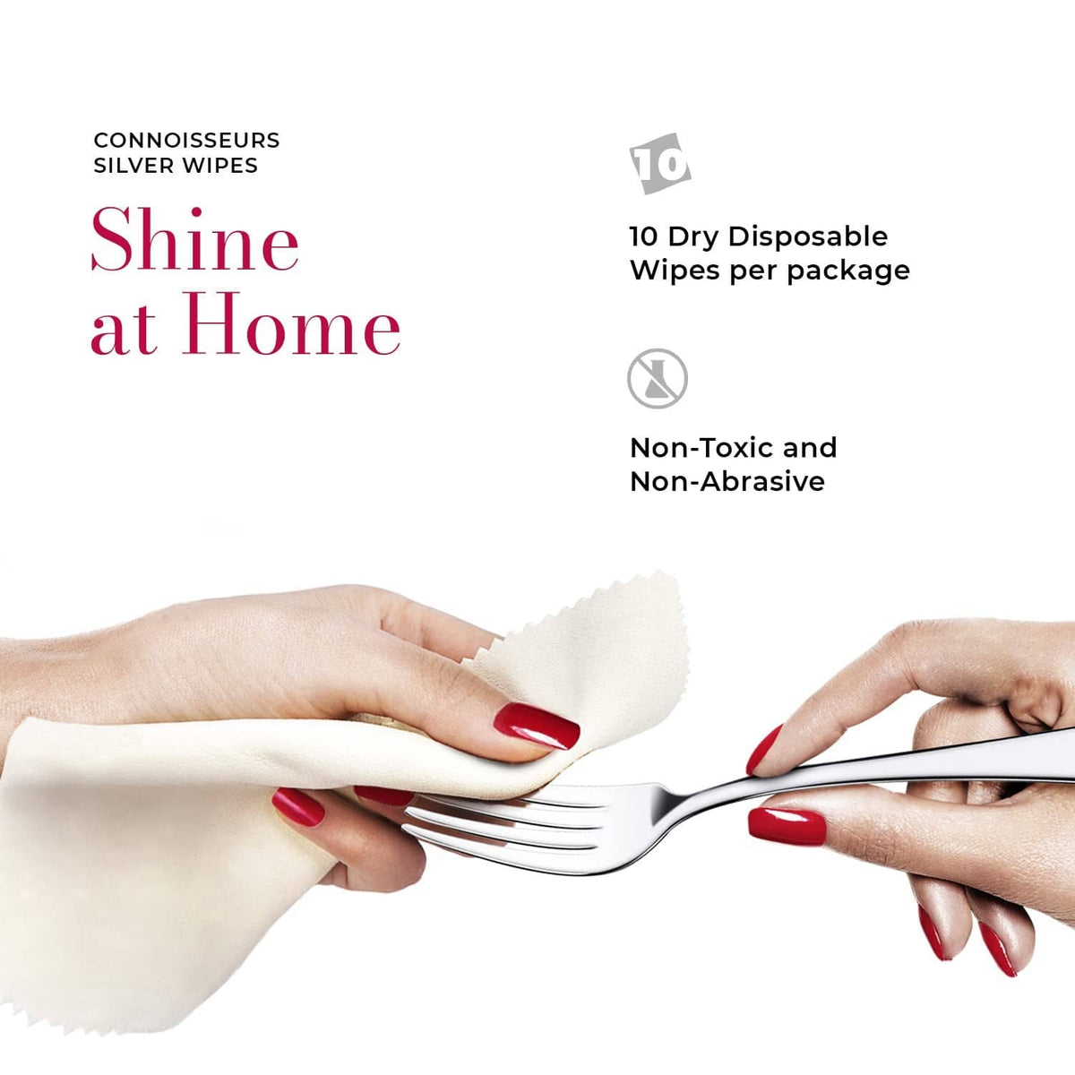 Silver cleaner wipes in hand, wiping a fork with a dry disposable cloth