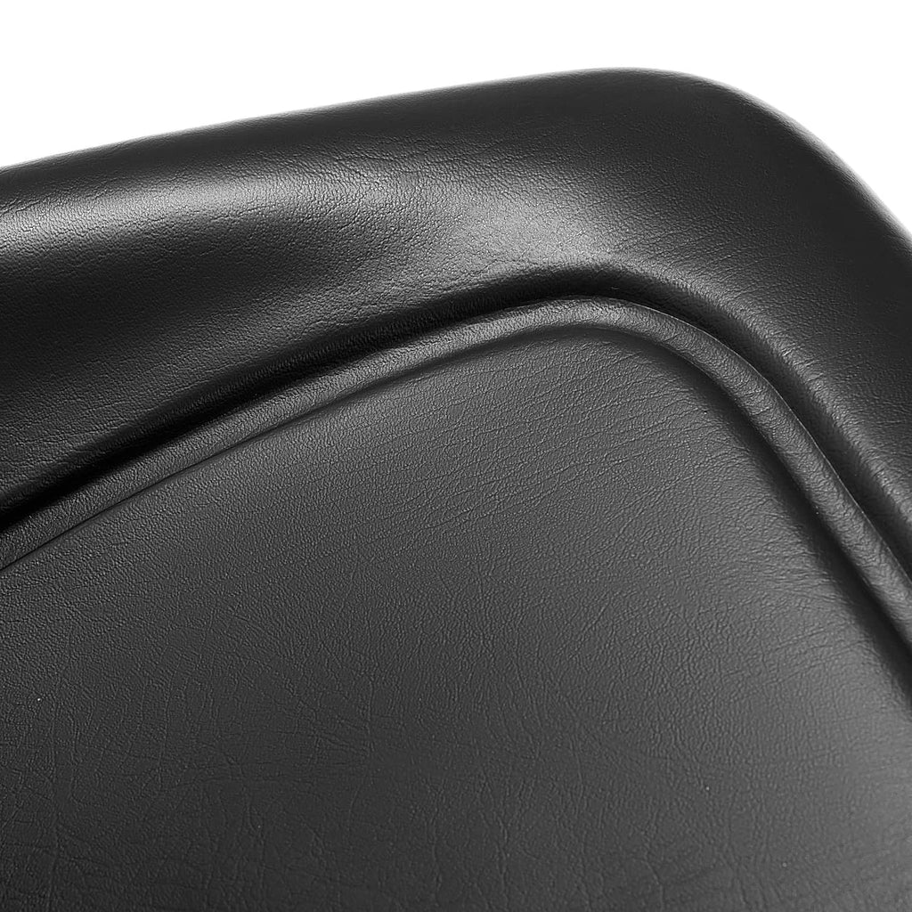 Black molded seat backrest with textured vinyl finish and curved edge seams.