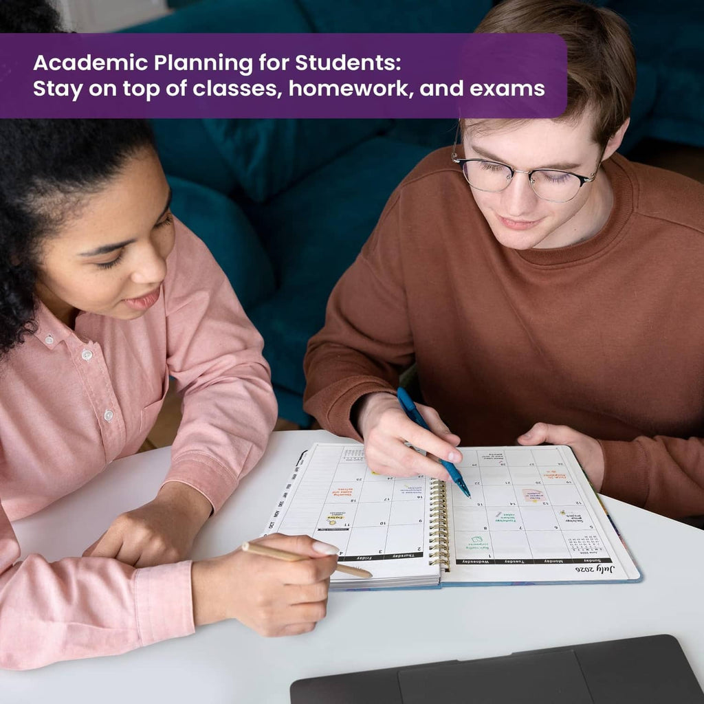 People writing in an academic planner on a desk; colorful 2026–2027 pages visible