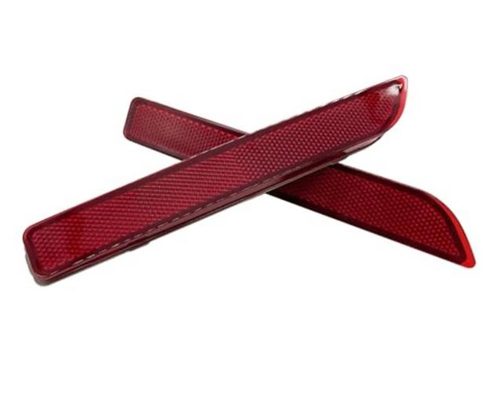 Two red rear bumper reflector lenses crossed, textured surface on each
