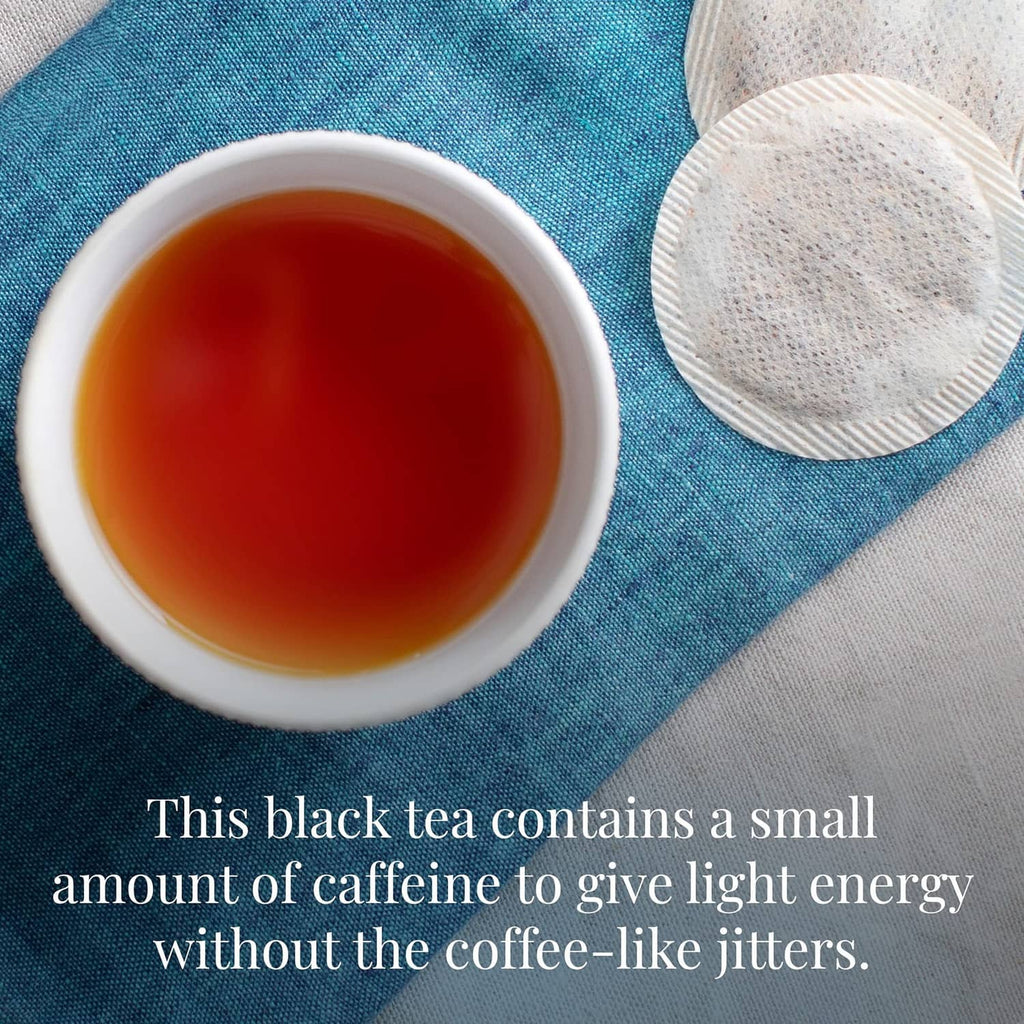Steeped cup of dark tea with two round tea filters