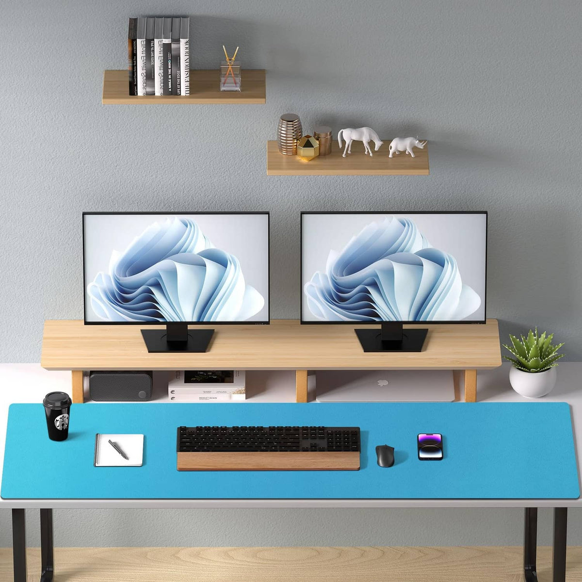 Turquoise leather desk pad protector on a wooden office desk