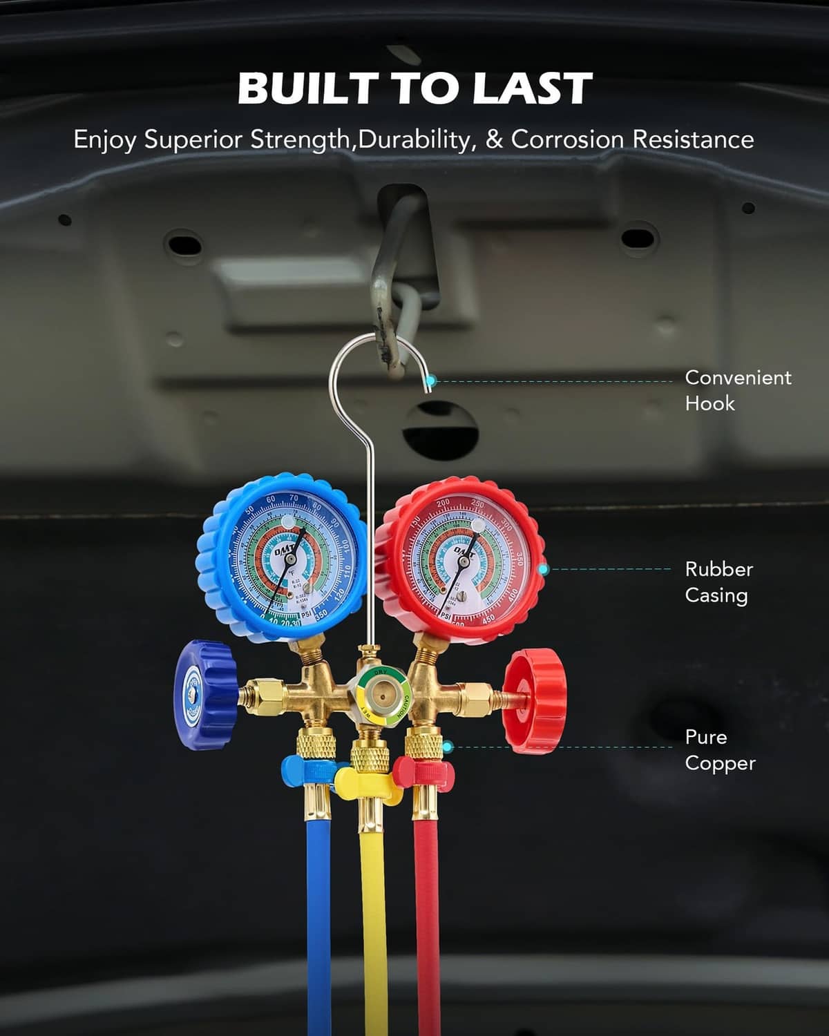 3-way AC manifold gauge assembly with rubber-cased dials, copper valves, and mounting hook