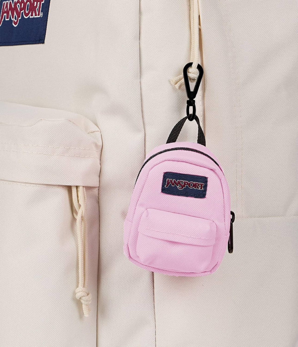 Pink JanSport mini backpack with front pocket and black keyring-style clip