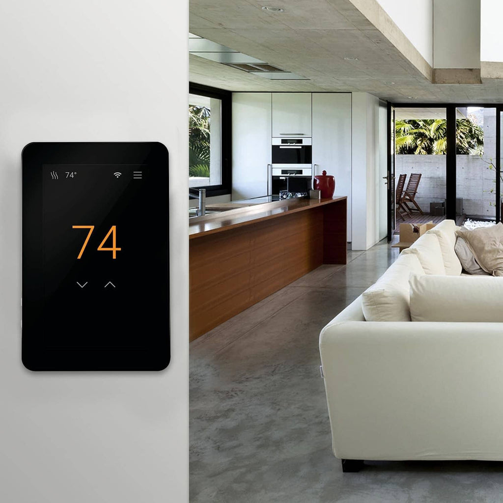 Black touchscreen thermostat on wall with 74°F temperature