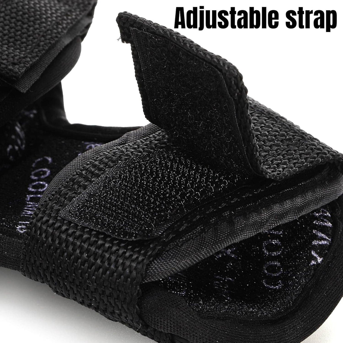 Close-up black wrist guard strap with adjustable tab over hard plastic shell