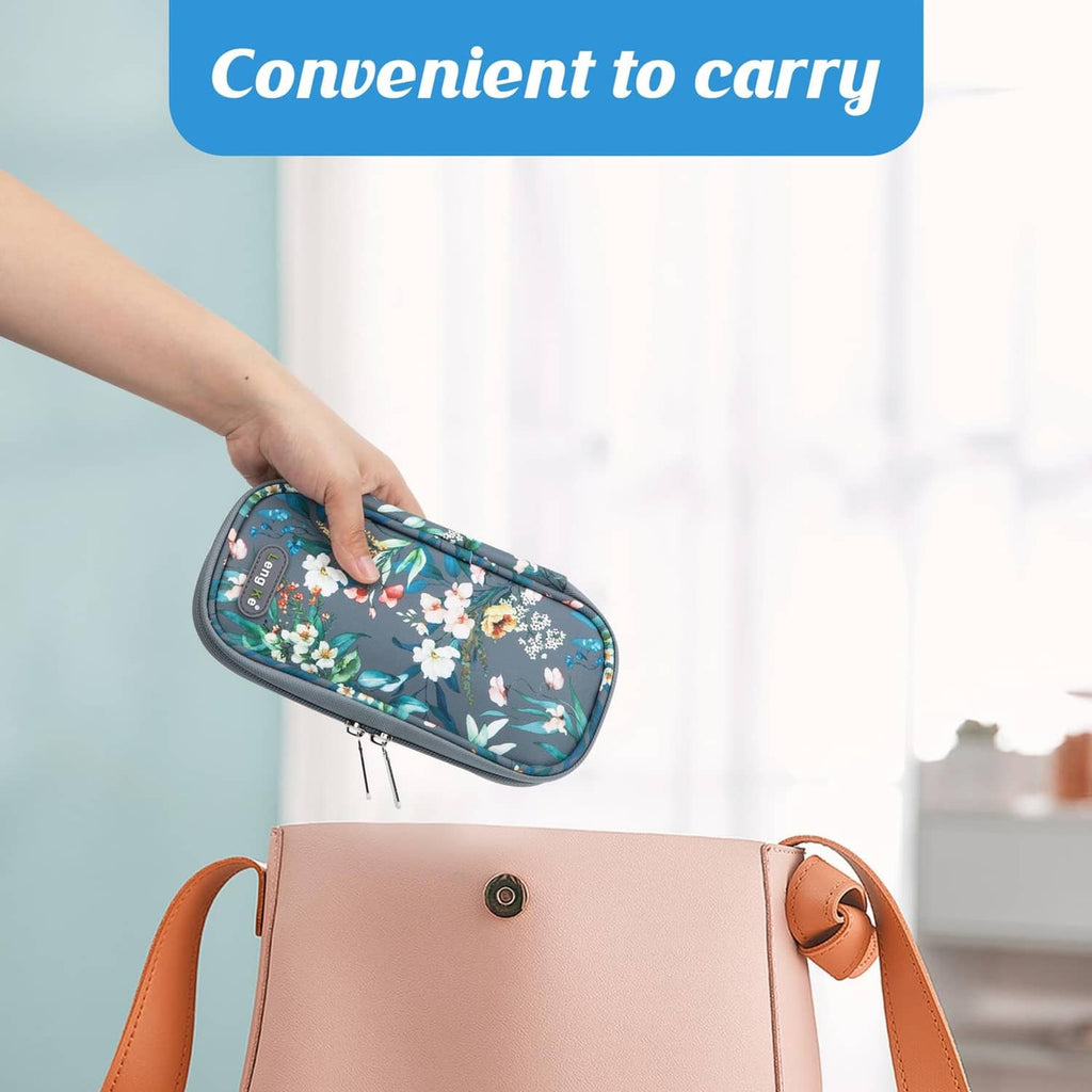 Small floral insulin cooler case held in hand, grey trim and zipper closure