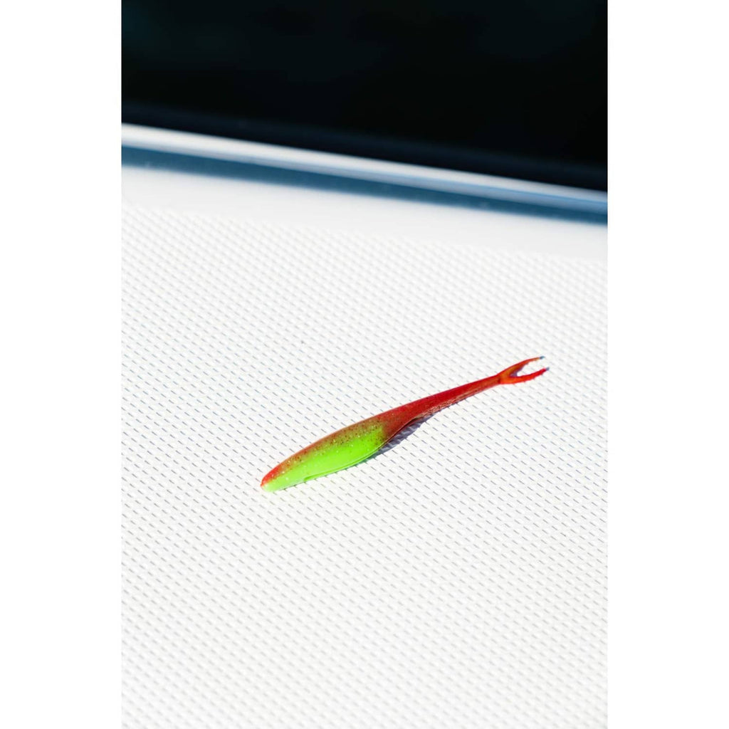 Green and red soft bait lure on mesh with attached hook