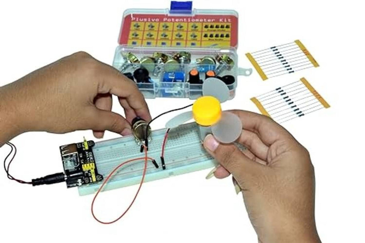 Hands assembling potentiometers on a breadboard with kit components and screwdriver tool