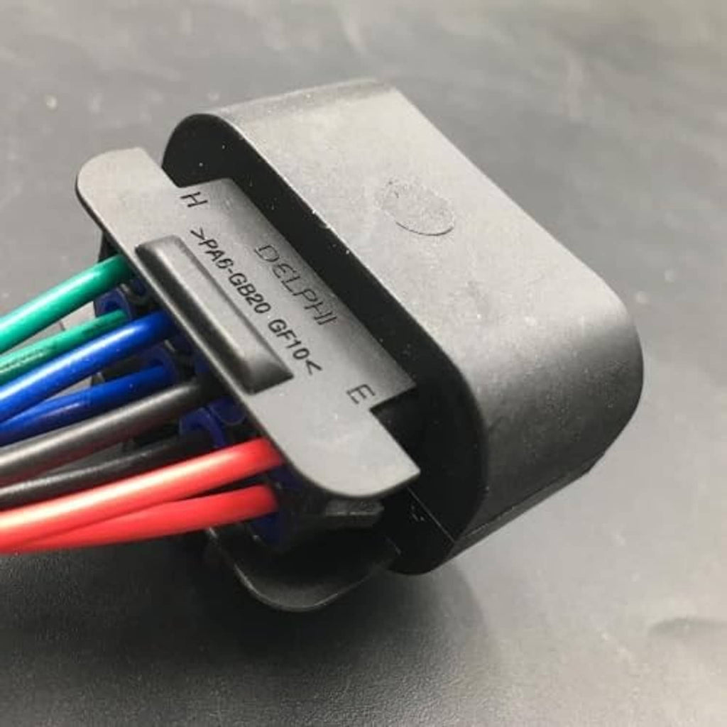 Black connector housing with embossed code and multicolor wire leads attached
