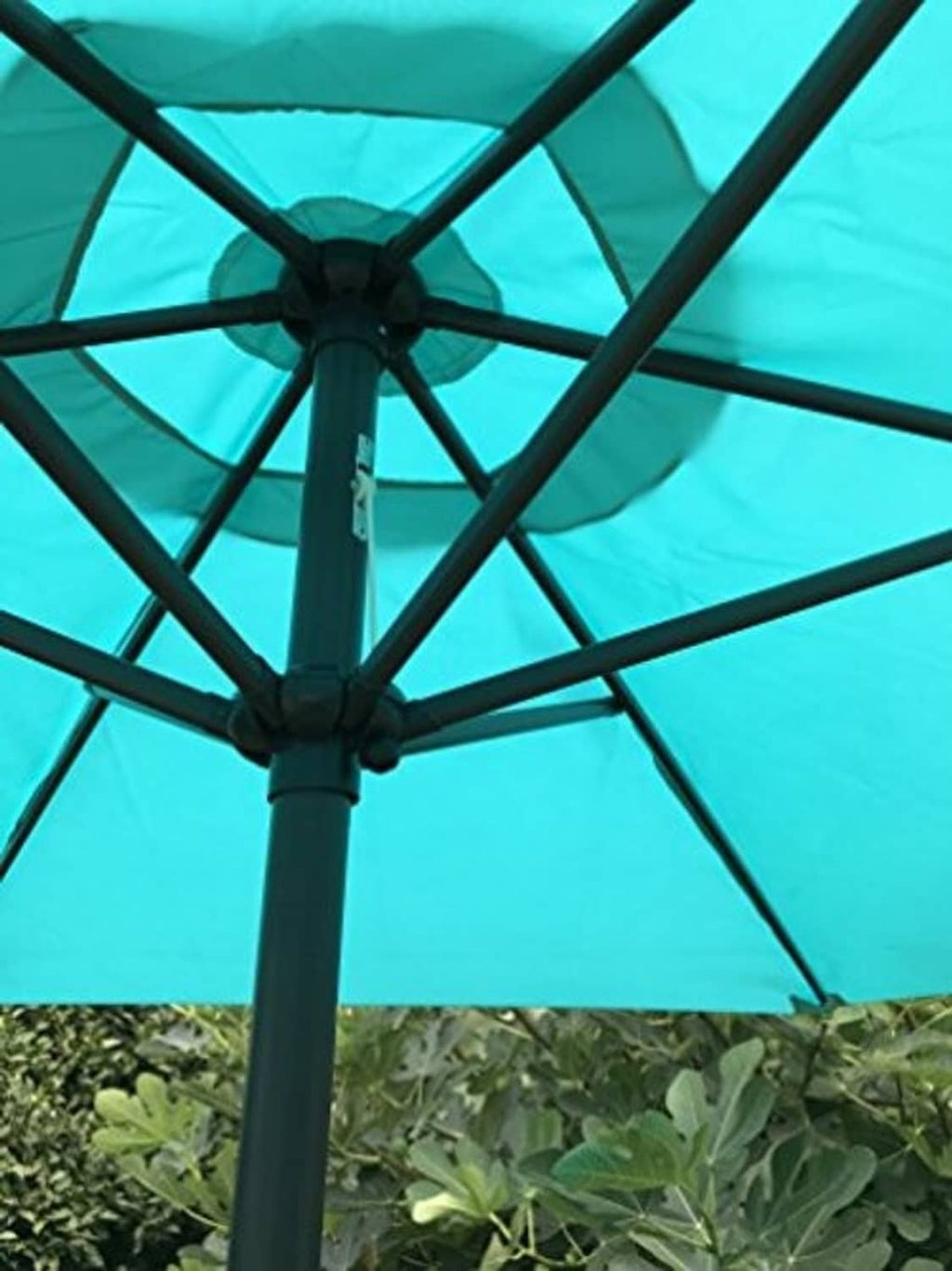 Umbrella canopy showing black rib frame through peacock blue fabric