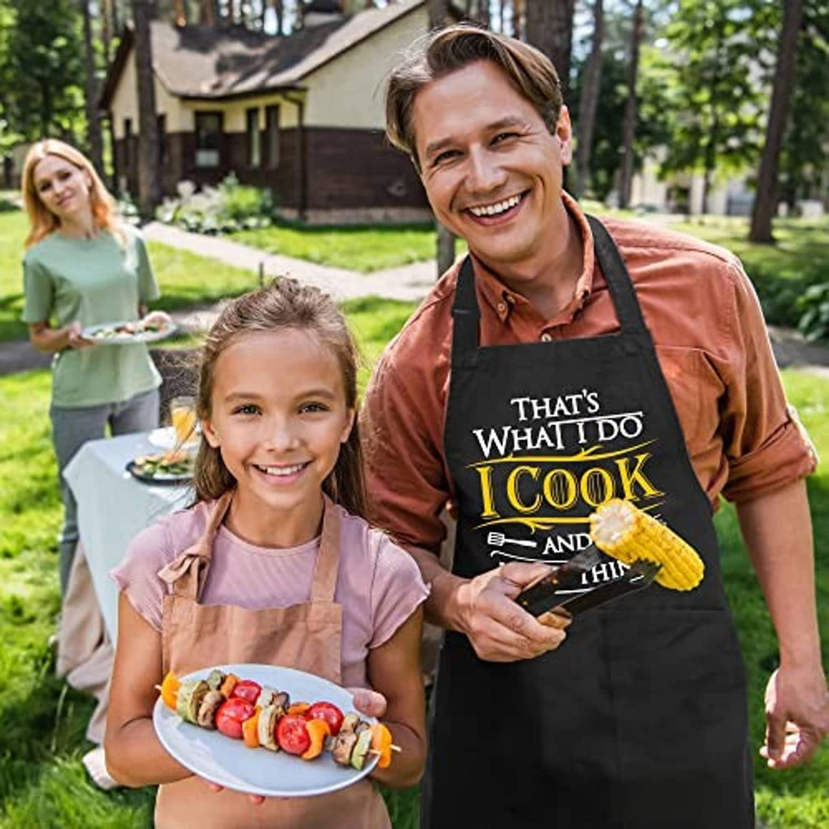 Black grilling aprons worn by family, with 'I Cook' chest print and large pockets