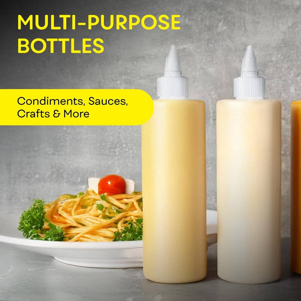 Three empty condiment squeeze bottles in light yellow tones with pointed nozzle caps