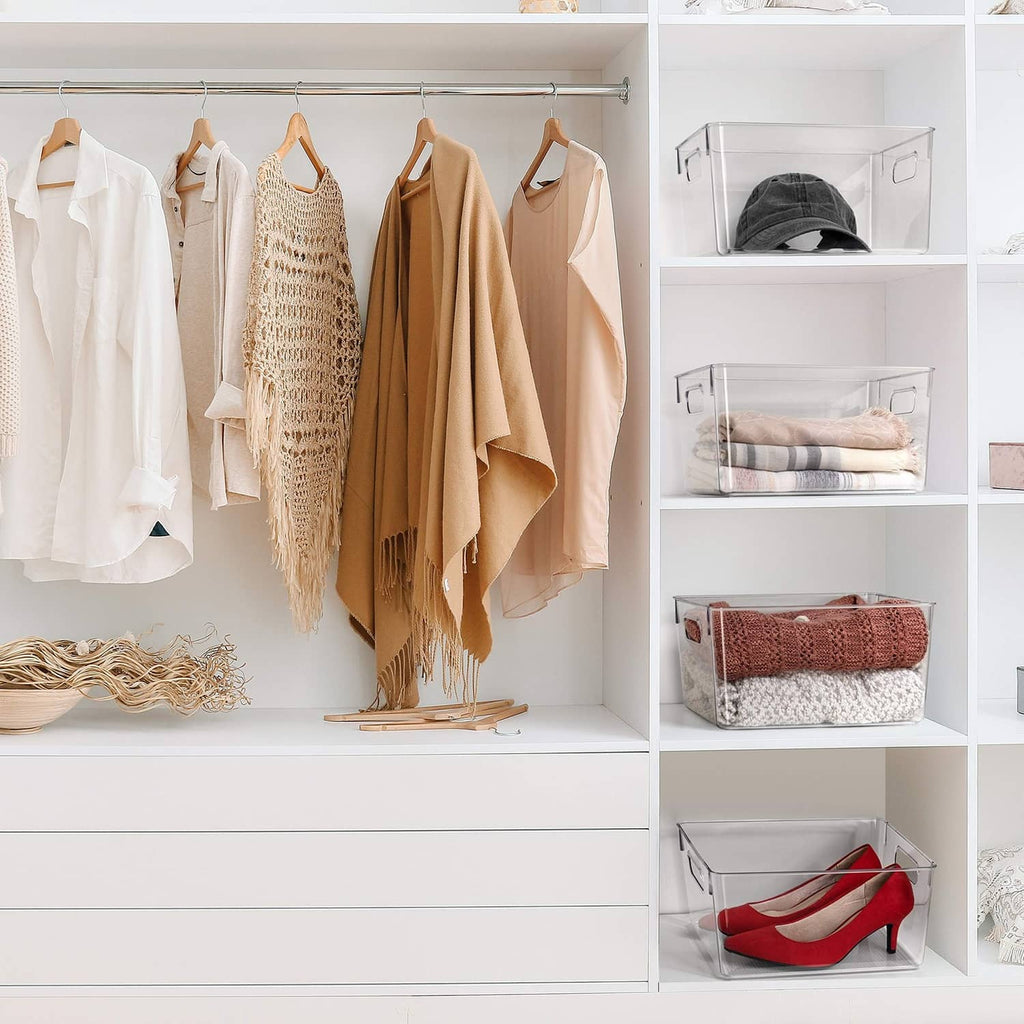 Clear plastic storage bin with side handles on closet shelf for folded items