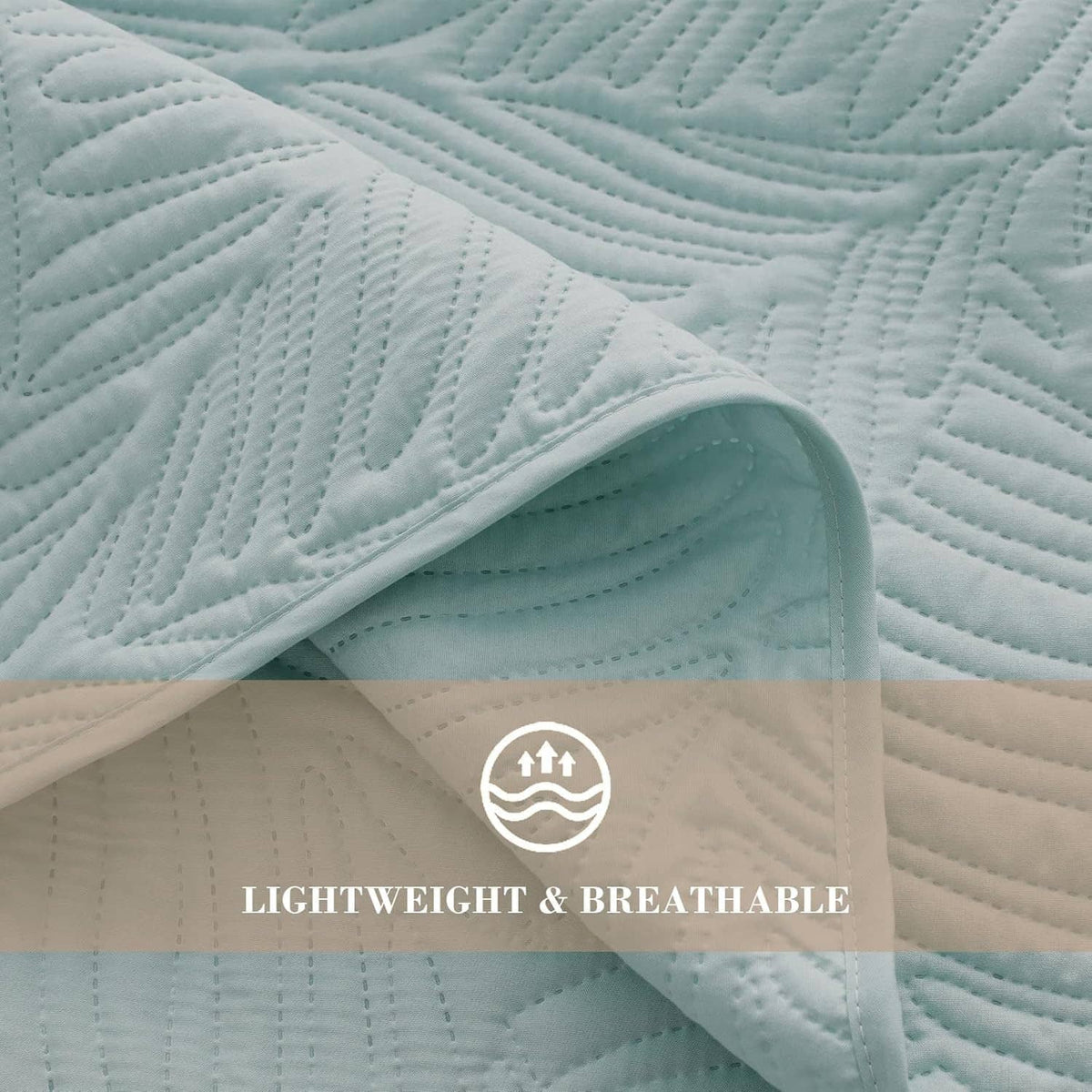 Aqua blue quilt close-up with quilted leaf texture and stitched channels